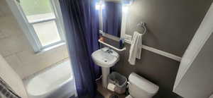 Full bath with toilet and shower / bath combo