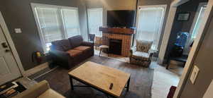 Living room featuring a tiled fireplace and wood finished floors