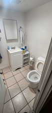 Bathroom with tile patterned floors and vanity
