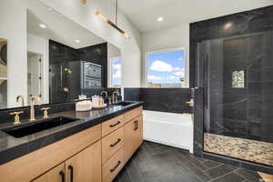 Bathroom with a stall shower, double vanity, a garden tub, tile patterned flooring, and recessed lighting