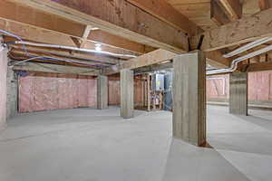 Unfinished basement featuring tankless water heater