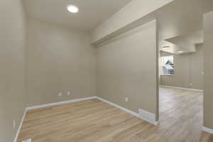 Empty room featuring light wood finished floors and baseboards