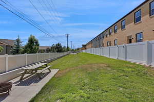 Fenced backyard with a patio and a fire pit