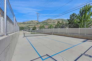 View of tennis court with a mountain view