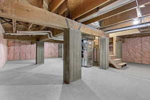 Unfinished basement featuring stairs