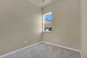 Unfurnished room featuring carpet and baseboards