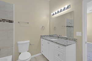 Bathroom with vanity, a shower, marble finish floors, and a bathtub