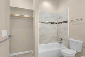 Full bathroom featuring bathtub / shower combination and toilet