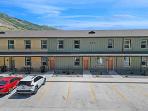 View of front facade featuring a mountain view, uncovered parking, and board and batten siding