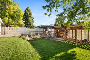 Fenced backyard featuring exterior structure and an outdoor structure