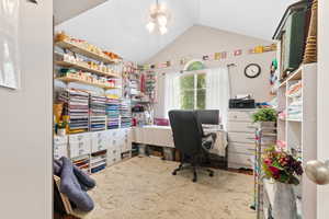 Office space with a ceiling fan and lofted ceiling