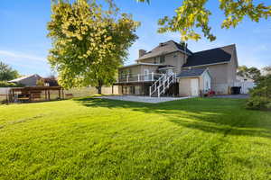 Back of house featuring a patio area, a fenced backyard, stairs, and a shed