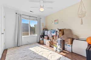 Bedroom featuring wood finished floors and ceiling fan