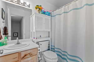 Bathroom with vanity and a shower with shower curtain