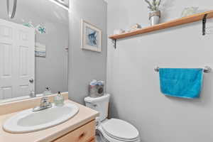 Half bath featuring vanity and toilet