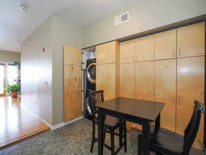 Dining room with stacked washer / drying machine and baseboards