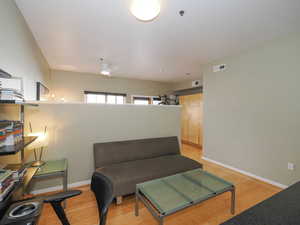 Sitting room featuring light wood-style flooring and baseboards