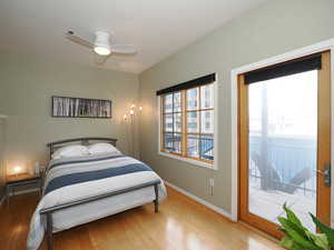 Bedroom featuring light wood-style flooring, baseboards, and a ceiling fan