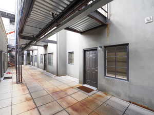 Property entrance with stucco siding and a patio area