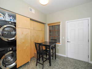 Dining space featuring stacked washer and clothes dryer and baseboards