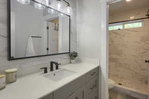 Bathroom with a tile shower and vanity
