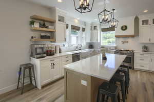 Kitchen featuring appliances with stainless steel finishes, a chandelier, decorative backsplash, a kitchen breakfast bar, and recessed lighting
