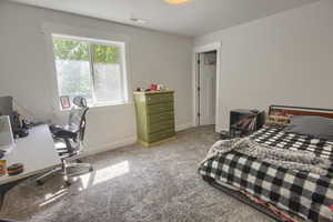 Carpeted bedroom with baseboards