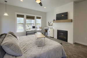 Bedroom featuring carpet flooring, recessed lighting, a tile fireplace, and ceiling fan
