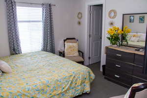 Bedroom featuring dark colored carpet