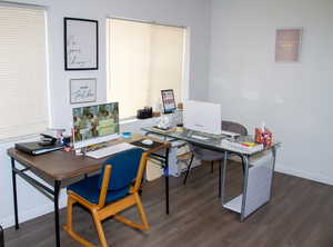 Home office featuring dark wood-style floors and baseboards