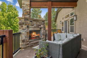 View of patio featuring an outdoor living space with a fireplace