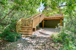 View of yard with stairs and a wooden deck