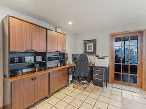 Home office with light tile patterned flooring and recessed lighting