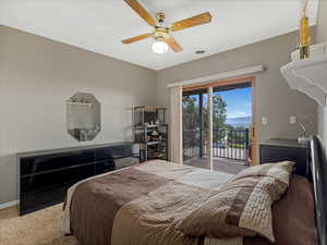 Carpeted bedroom with access to outside and a ceiling fan