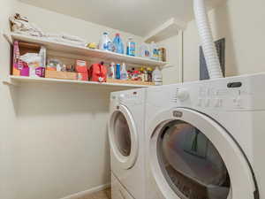 Washroom featuring washing machine and clothes dryer