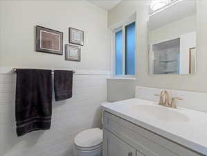 Bathroom featuring vanity and toilet