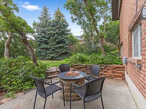View of patio with a fire pit