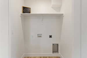 Laundry room featuring hookup for a washing machine, light wood finished floors, and electric dryer hookup