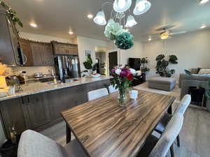 Dining room featuring a ceiling fan, light wood finished floors, and recessed lighting