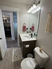 Bathroom with wood finished floors and vanity