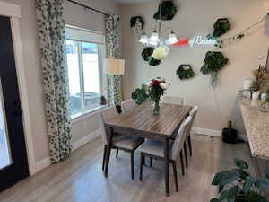 Dining space featuring a chandelier and light wood finished floors