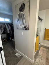 Hallway featuring a textured ceiling and wood finished floors