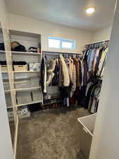 Walk in closet with carpet flooring