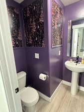 Bathroom featuring wood finished floors and a textured ceiling