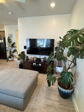 Living area featuring wood finished floors, ceiling fan, and recessed lighting