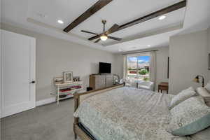 Carpeted bedroom featuring recessed lighting, beam ceiling, ceiling fan, and a raised ceiling