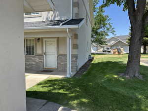 Doorway to property with stucco siding, and the park-like atmosphere