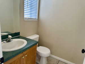 Half bathroom featuring vanity and tile patterned floors