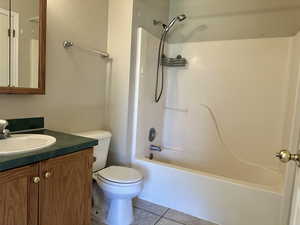 Full bathroom featuring tile patterned flooring, vanity, and washtub / shower combination