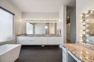 Full bathroom with a freestanding tub, double vanity, and tile patterned floors